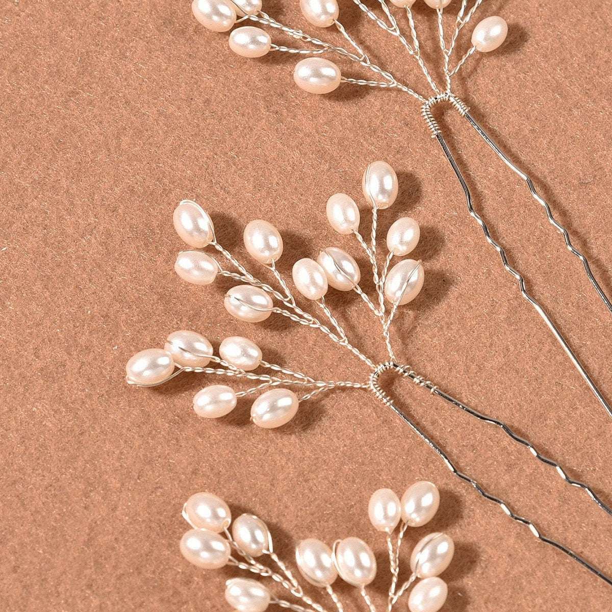 Close-up of the handmade pearl and wire detail on the hair pin