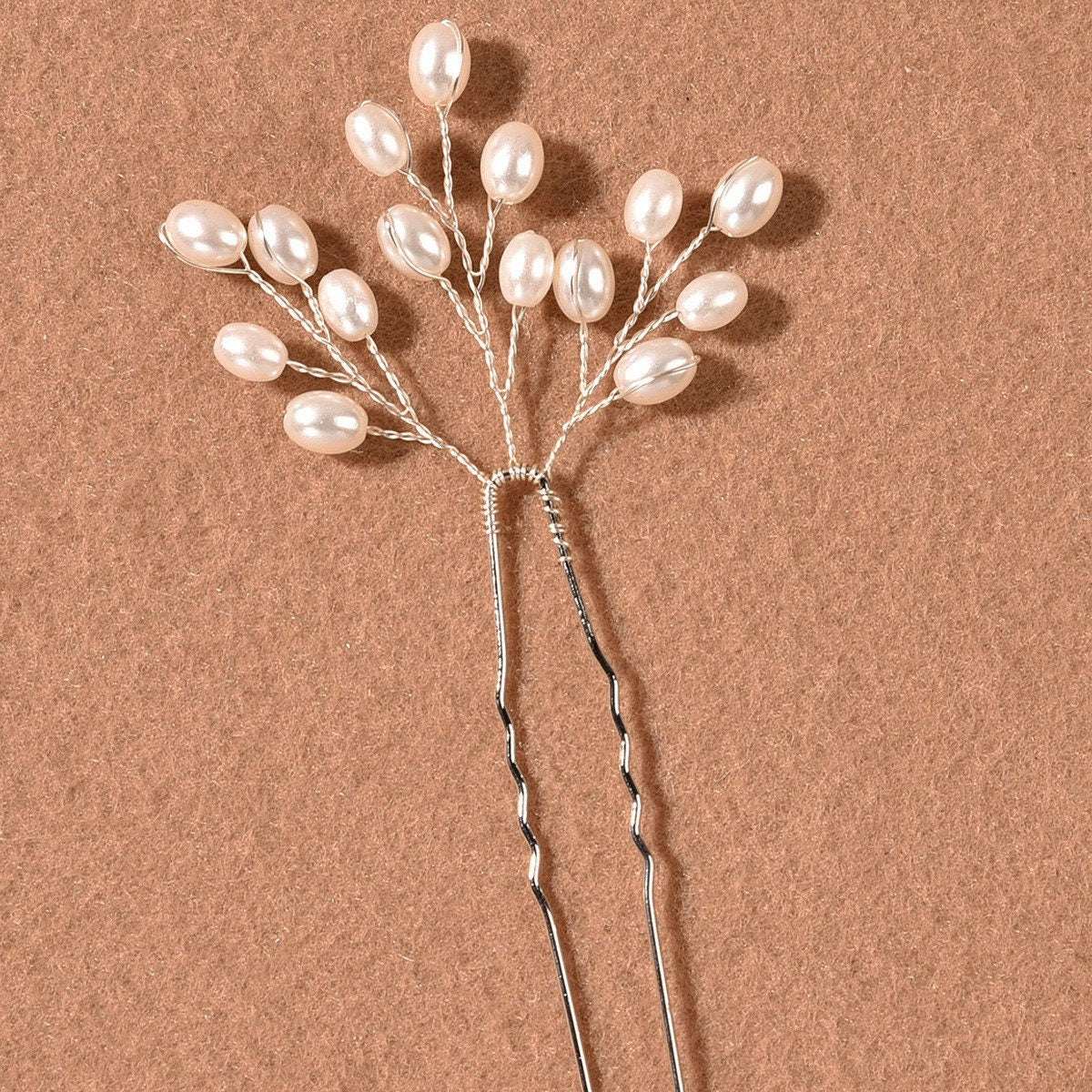 Detail of the lustrous pearls on the delicate branch hair pin