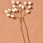 Detail of the lustrous pearls on the delicate branch hair pin