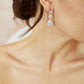 Side view of a bride wearing elegant crystal drop earrings
