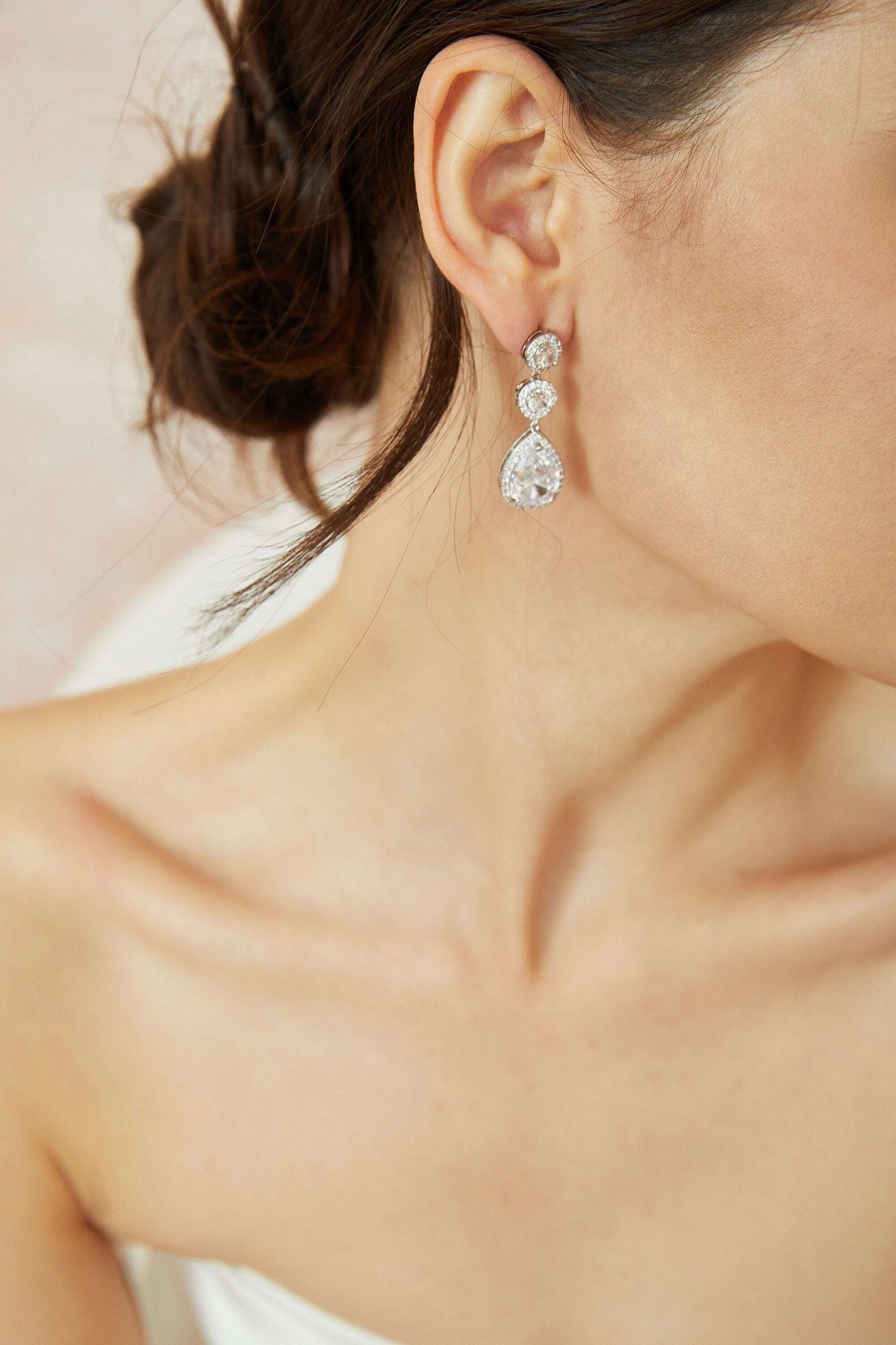 Side view of a bride wearing elegant crystal drop earrings