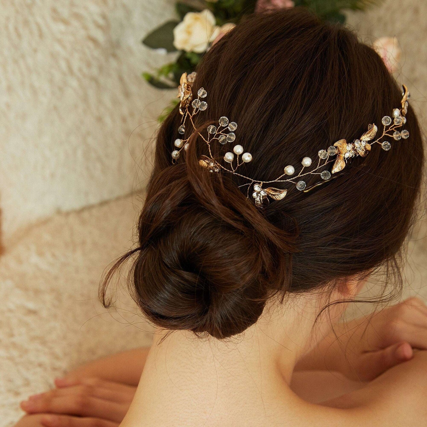 Model with wavy brown hair wearing a silver pearl and crystal hair comb