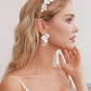 Skillfully handcrafted, these flower bridal earrings are the perfect complement to our signature porcelain headpieces. Each earring is exquisitely made by hand, featuring two delicate white clay flowers adorned with freshwater pearls.