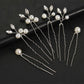 Set of 6 silver bridal hair pins with pearls and crystals on a black background