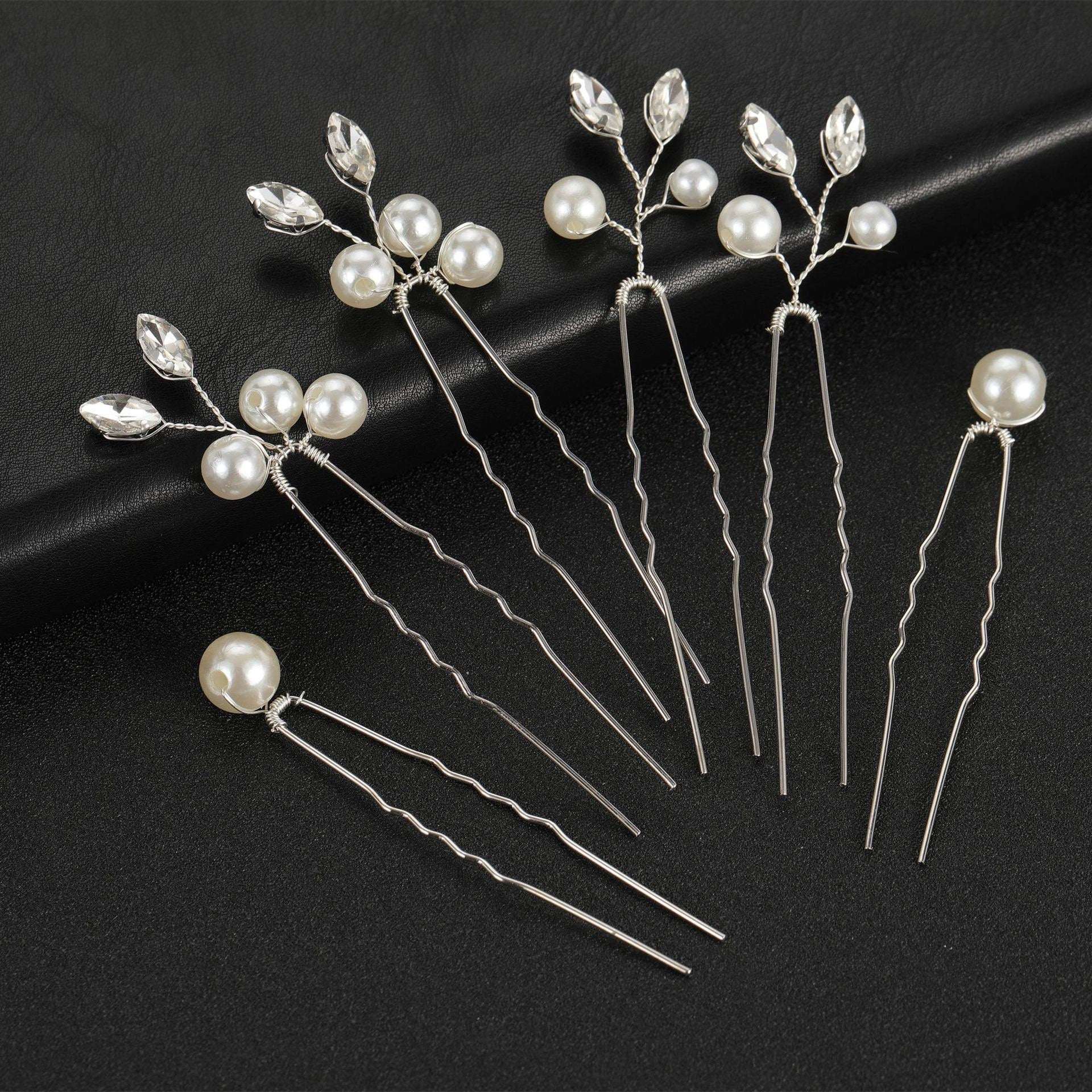 Set of 6 silver bridal hair pins with pearls and crystals on a black background