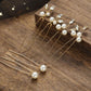 Close-up of handcrafted gold bridal hair pins with lustrous pearls on a wooden surface
