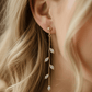14K Gold Olive Leaf Crystal Drop Earrings - three quarter face view, half updo hairstyle