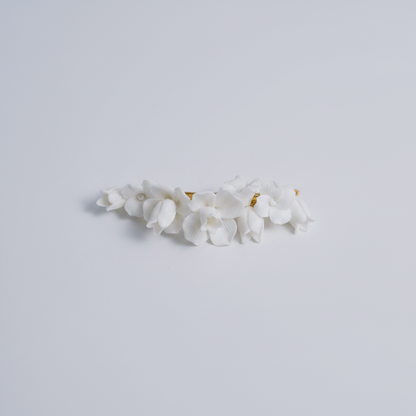 CHARLOTTE white porcelain flower hair clip in gold on a white background