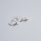 Side view of the CHARLOTTE white porcelain flower hair clip in silver