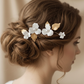 Bride wearing gold porcelain flower hair accessory in an elegant wedding updo