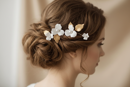 Bride wearing gold porcelain flower hair accessory in an elegant wedding updo