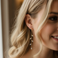 14K gold olive leaf crystal drop earrings worn by bride, elegant bridal styling