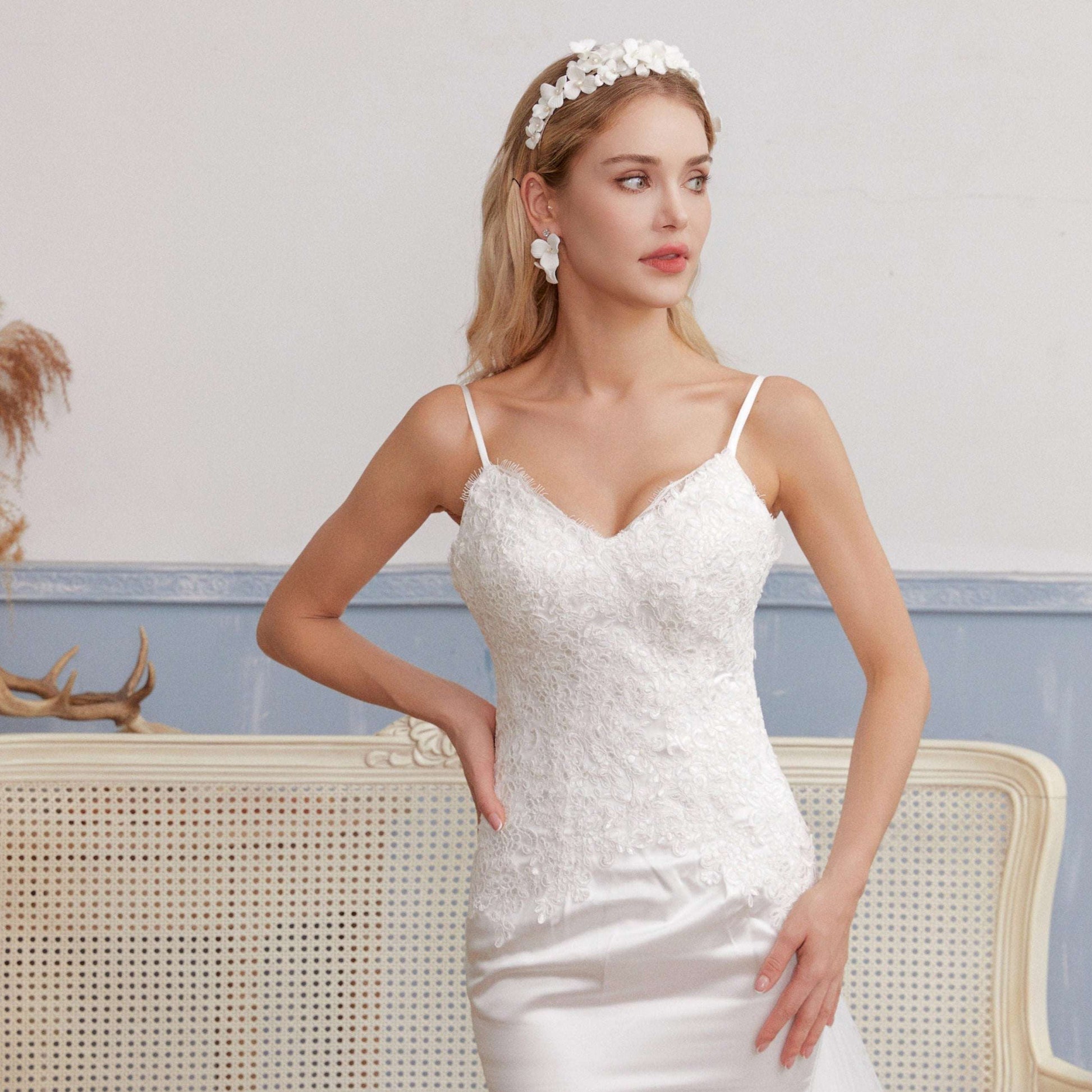 A gloriously romantic hand-sculpted porcelain bridal crown. Made with an arrangement of individually crafted flowers and dainty pearls. This full and textured headband makes a statement but yet still feels incredibly feminine.