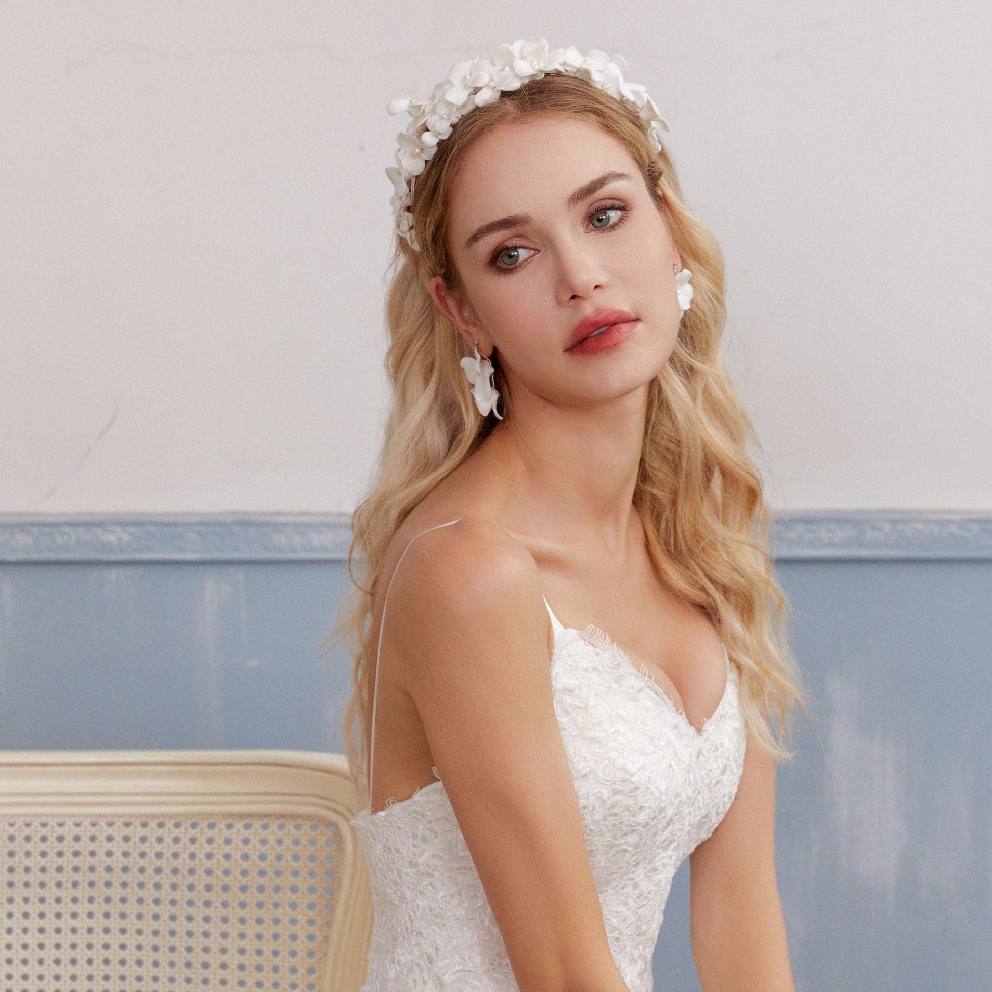 A gloriously romantic hand-sculpted porcelain bridal crown. Made with an arrangement of individually crafted flowers and dainty pearls. This full and textured headband makes a statement but yet still feels incredibly feminine.