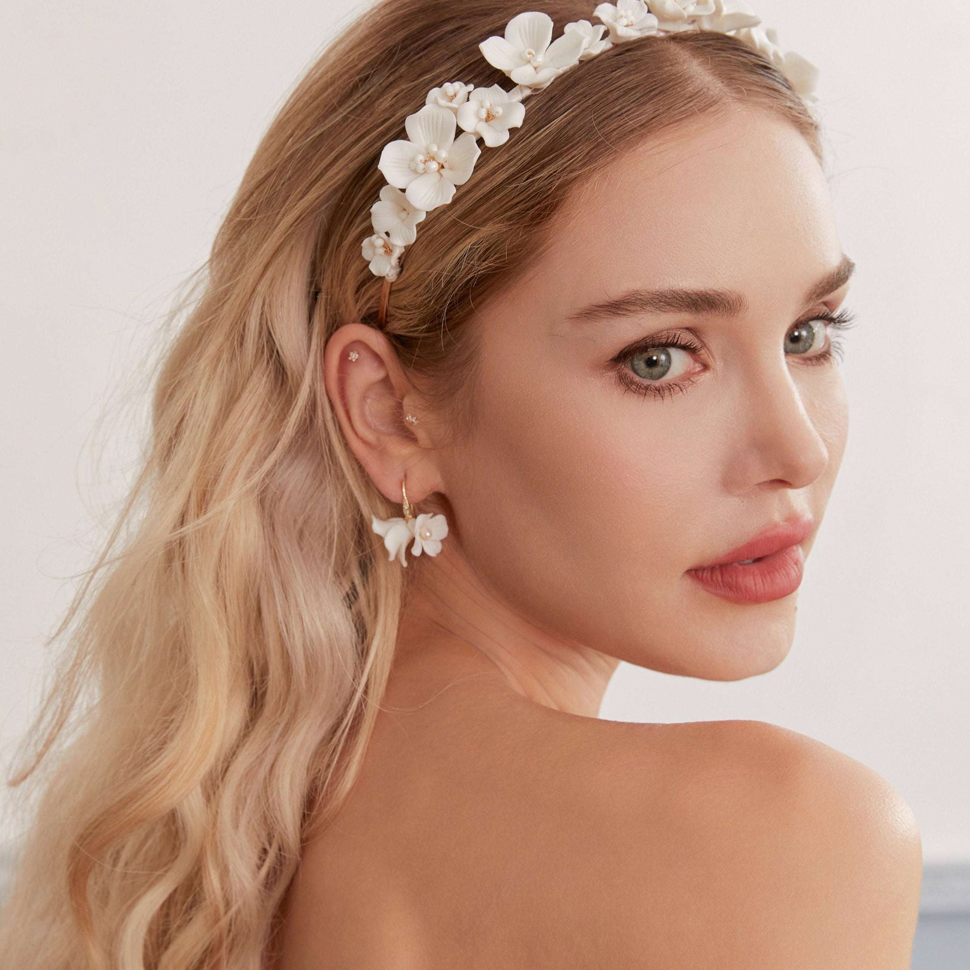 Bride looking over her shoulder, wearing LILY porcelain pearl earrings