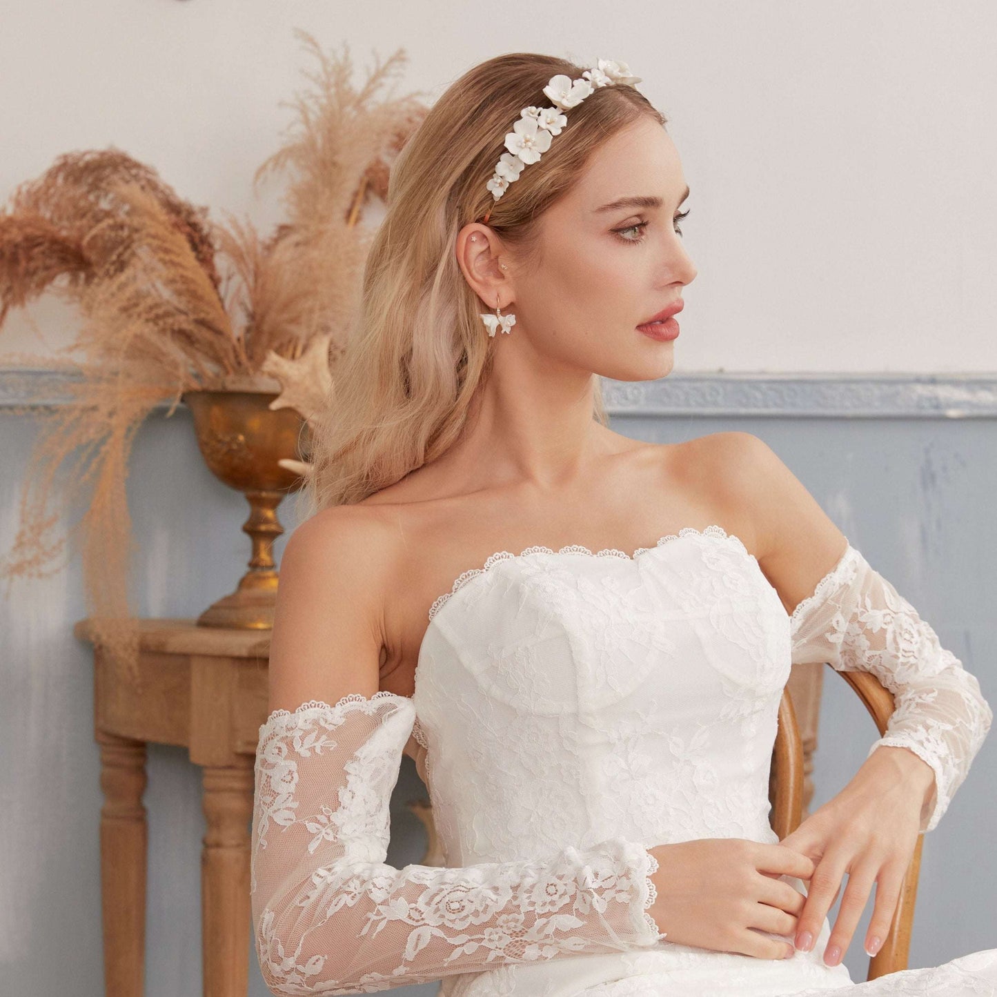 Bride in a lace wedding dress wearing the LILY porcelain pearl earrings