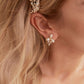 These stunning earrings feature leaf-like zirconia crystals that shimmer beneath three delicate pearls, evoking the graceful beauty of blooming flowers.