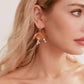 This slimline, modern gold headband is made from the most beautiful freshwater pearls and shimmering rhinestones. The minimalist floral design and timeless luxury of pearls and stones are always in style.
