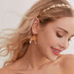 This slimline, modern gold headband is made from the most beautiful freshwater pearls and shimmering rhinestones. The minimalist floral design and timeless luxury of pearls and stones are always in style.