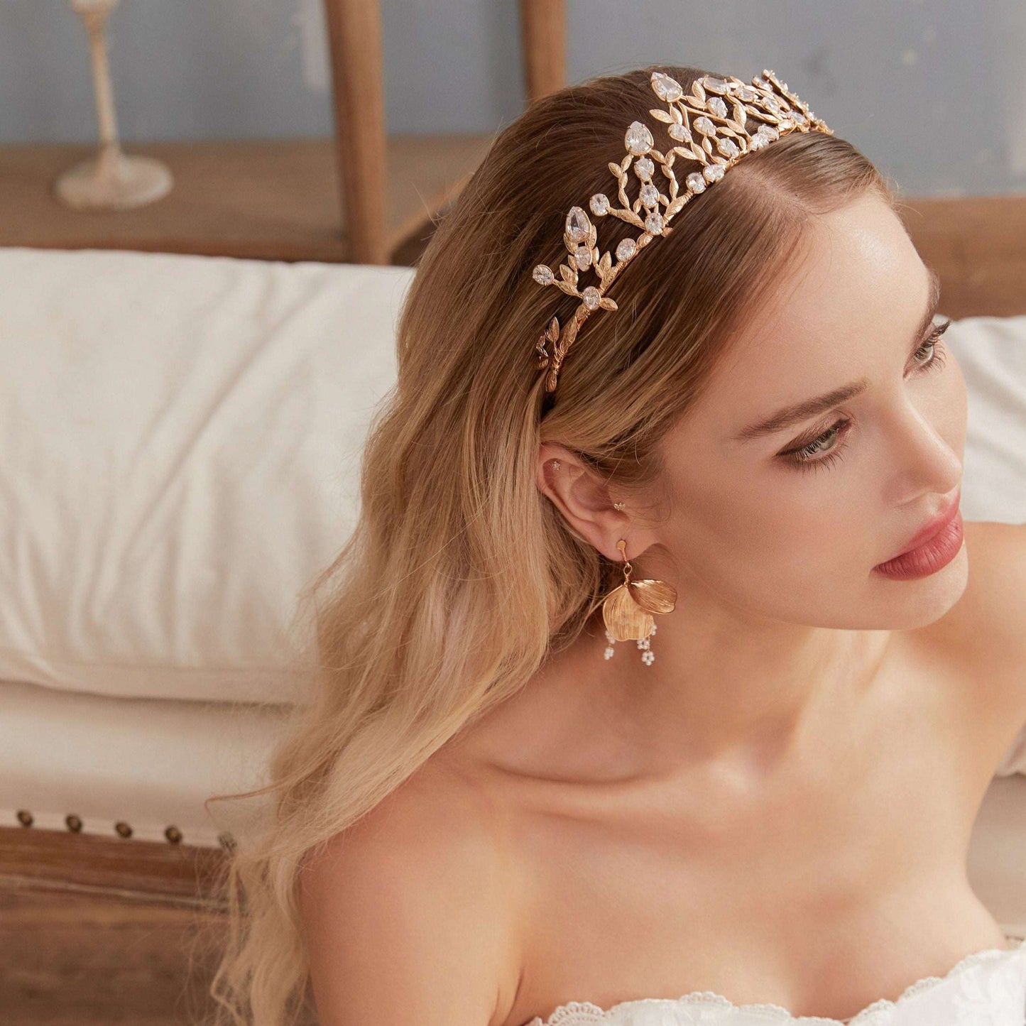 Victoria | Gold Crystal Bridal Crown Tiara - Handcrafted with attention to detail, this unique crown features delicate gold metal leaves intricately arranged alongside an array of dazzling rhinestone flowers in various sizes. The combination of gold and crystals creates a vintage-inspired woodland feel. 
