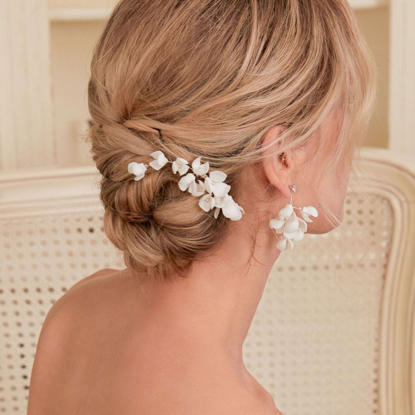 Bride wearing the OLIVIA floral drop earrings and a braided updo