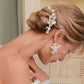 Model looking down, showcasing the OLIVIA handmade floral drop earrings