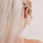 Luxurious single-layer cathedral wedding veil crafted from delicate sparkle glitter tulle. With an ivory base (also available in white and champagne), it features a simple cut edge for an elegant and timeless style that complements any bridal look.  At 3 meters long, this veil is the perfect bridal accessory to enhance any wedding dress. Offering a subtle sparkle without any fuss, it adds a touch of glamour to your special day.