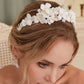 A gloriously romantic hand-sculpted porcelain bridal crown. Made with an arrangement of individually crafted flowers and dainty pearls. This full and textured headband makes a statement but yet still feels incredibly feminine.