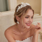 Skillfully handcrafted, these flower bridal earrings are the perfect complement to our signature porcelain headpieces. Each earring is exquisitely made by hand, featuring two delicate white clay flowers adorned with freshwater pearls.