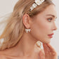 these flower bridal earrings  feature two delicate white clay flowers adorned with freshwater pearls and crystal-embellished French hooks that create a brilliant sparkle with every move.