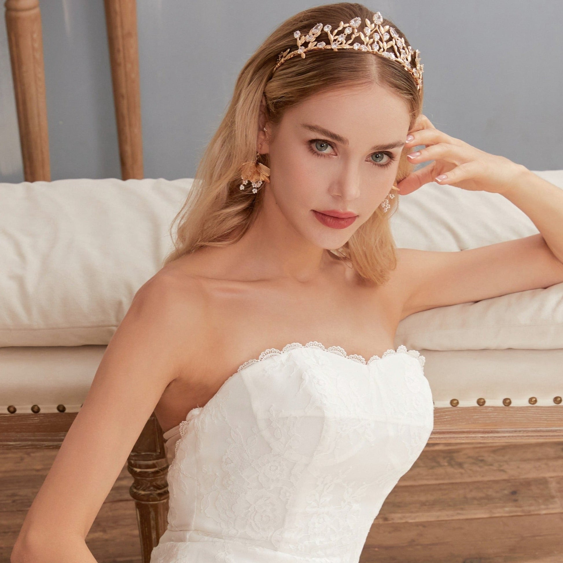 Victoria | Gold Crystal Bridal Crown Tiara - Handcrafted with attention to detail, this unique crown features delicate gold metal leaves intricately arranged alongside an array of dazzling rhinestone flowers in various sizes. The combination of gold and crystals creates a vintage-inspired woodland feel. 