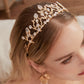 Victoria | Gold Crystal Bridal Crown Tiara - Handcrafted with attention to detail, this unique crown features delicate gold metal leaves intricately arranged alongside an array of dazzling rhinestone flowers in various sizes. The combination of gold and crystals creates a vintage-inspired woodland feel. 