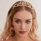 Victoria | Gold Crystal Bridal Crown Tiara - Handcrafted with attention to detail, this unique crown features delicate gold metal leaves intricately arranged alongside an array of dazzling rhinestone flowers in various sizes. The combination of gold and crystals creates a vintage-inspired woodland feel. 