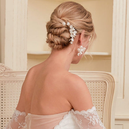 This hair comb is perfect for brides who want a modest and timeless look. It features delicate clay flowers and small beads that are arranged carefully to create a romantic and classic design.
