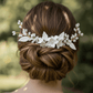 Nina handmade ceramic flower bridal hair comb featuring white porcelain petals and gold wire details on a white background.