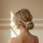 Model wearing the LILLIAN silver porcelain flower hairpin in a low bun