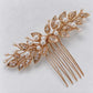 Diagonal product view of the gold leaf bridal comb with branching white bead details