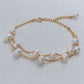 Video close-ups of a double-strand pearl bracelet showing gold chains and an extension chain
