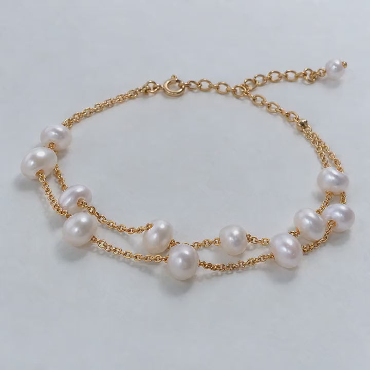 Video close-ups of a double-strand pearl bracelet showing gold chains and an extension chain