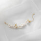 Adjustable floral bracelet with white ceramic blooms and leaf accents, gold chain bridal wrist jewellery
