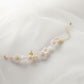 Adjustable floral bracelet with white ceramic blooms and leaf accents, gold chain bridal wrist jewellery