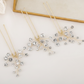 Delicate pearl bridal hair pin with silver stem laid flat