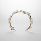 Side view of handmade white porcelain floral bridal halo with delicate gold leaf detailing